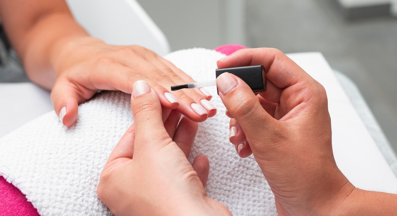 high-angle-woman-doing-manicure-client